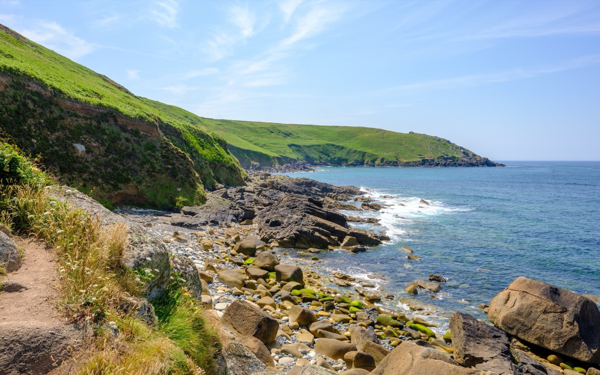 The coast at Zennor Head, Cornwall, with green cliffs running down to the sea